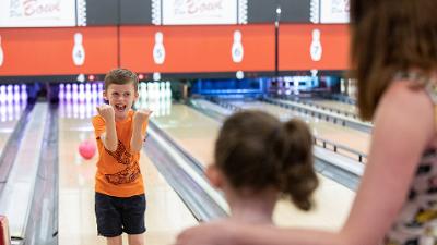 Family enjoying a game of bowling at The Dunes