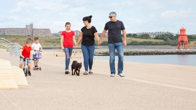 Family walking along Littlehaven Promenade 