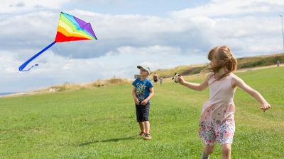 Children flying kite on leas